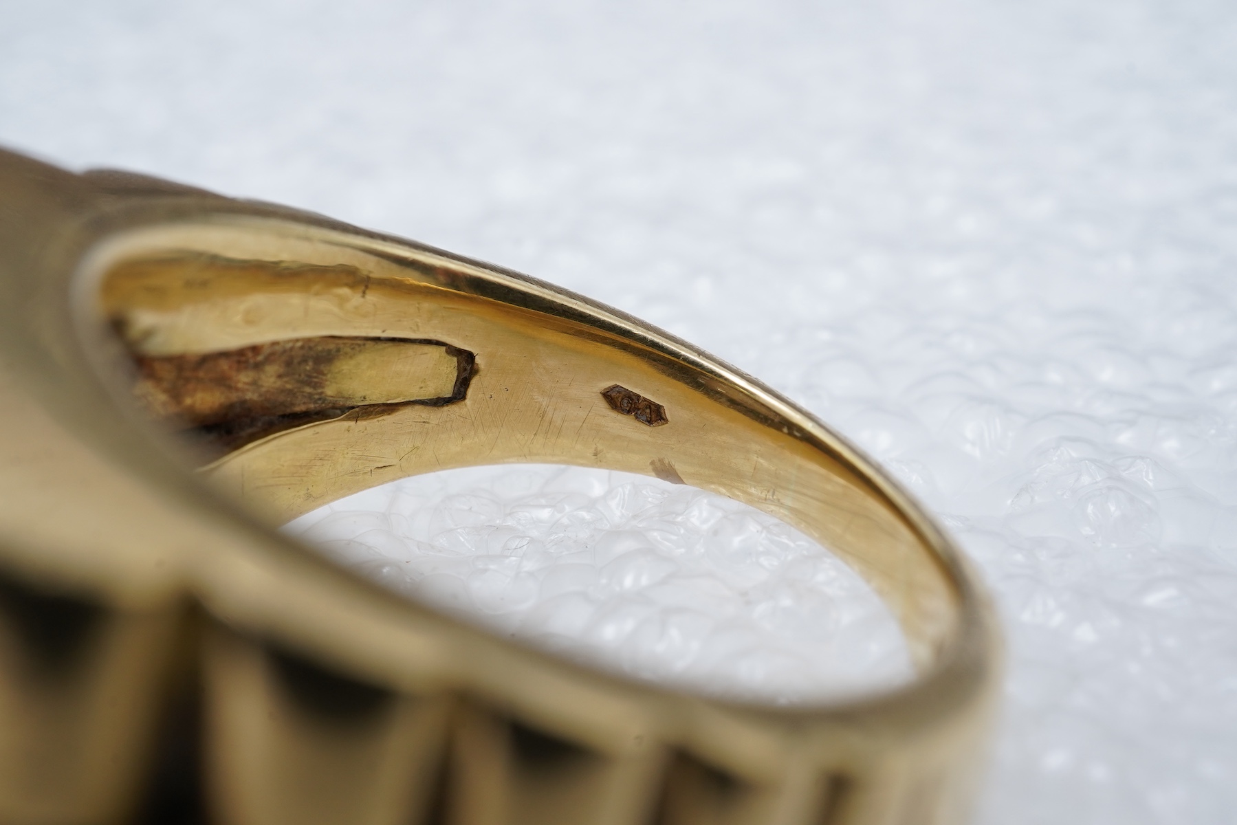 A gold and diamond signet ring